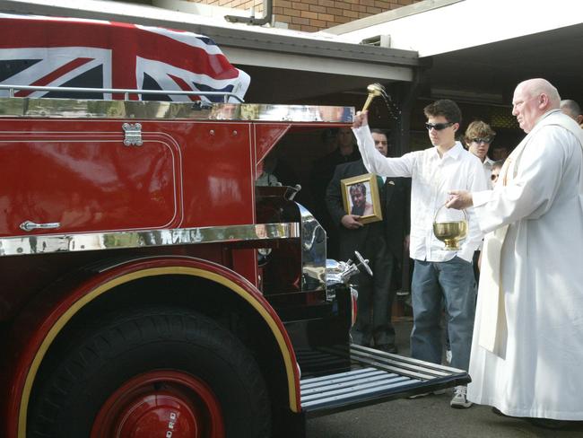 Family bless the coffin of firefighter Phillip Viles, outside St (Saint) Marys Catholic Church at Noraville on Central Coast during his funeral service. Picture: Renee Nowytarger