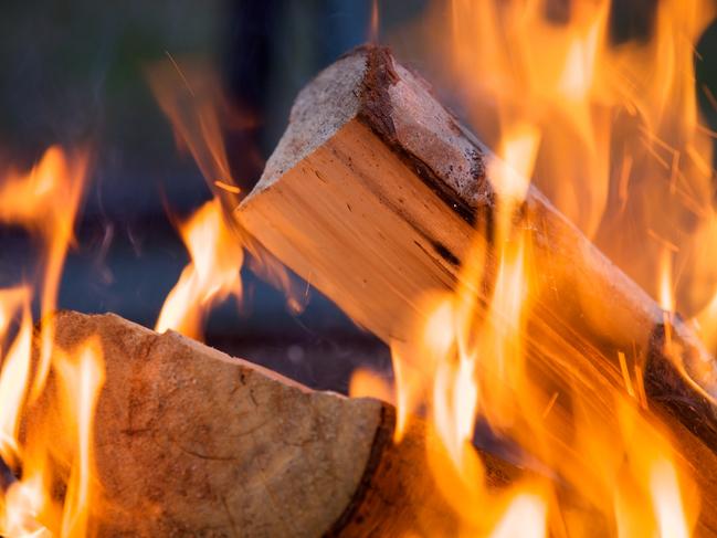 Burning firewood at campfire