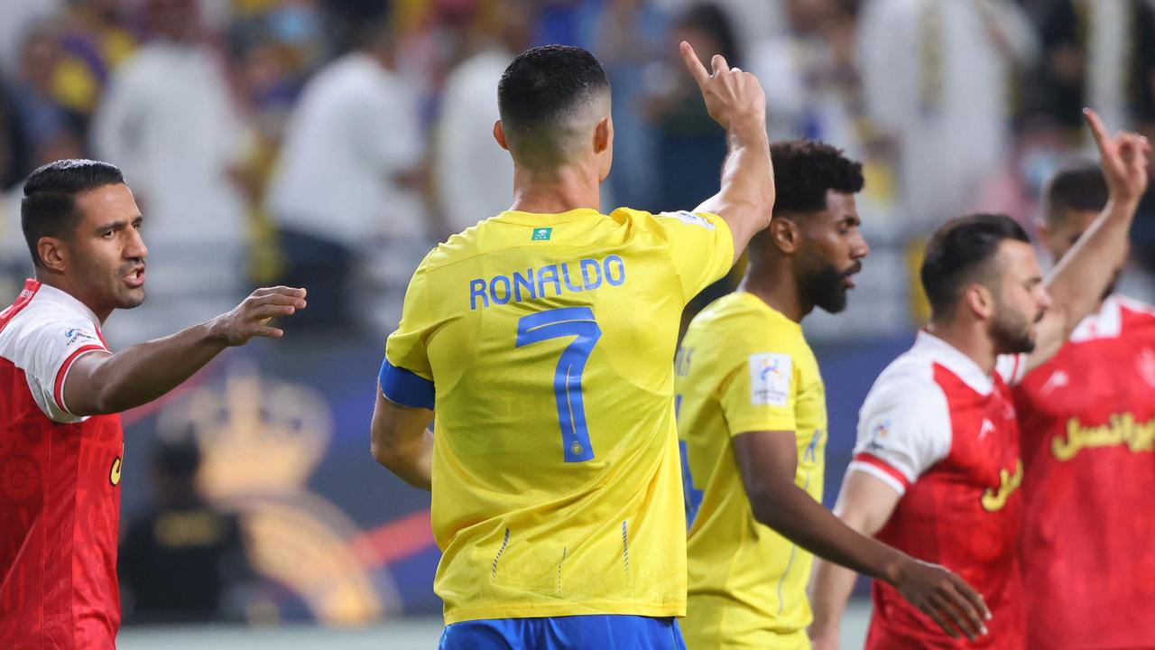 Cristiano Ronaldo tells the referee that there was no foul and no need for a penalty during the AFC Champions League Group E football match between Saudi's al-Nassr and Iran’s Persepolis at the Al-Awwal Stadium in Riyadh.