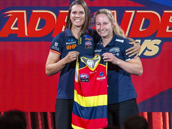 Crows co-captain Chelsea Randall presents her guernsey to new draftee Nikki Gore during the 2018 AFLW Draft at Marvel Stadium in Melbourne on October 23, 2018. Picture: AAP Image/Daniel Pockett