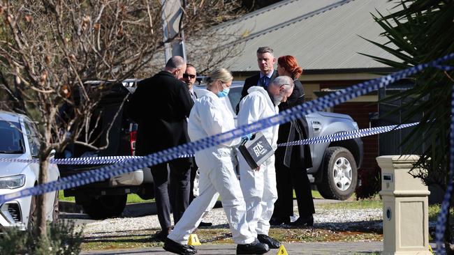 Police, detectives and sniffer dog at the scene on Elm Rd. Image/Russell Millard Photography