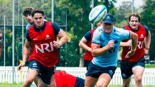 Waratahs five-eighth Tane Edmed chases a kick during training at NSW Rugby's practice field in Daceyville.