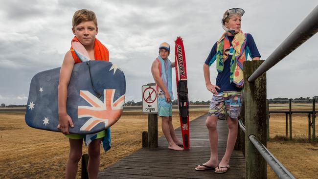 Damon Grigg (9), Aaron Towbridge (15) and Hayden Trowbridge (15) stand on a jetty at a completely dry Lake Wallace in Edenhope in Western Victoria. Recent rains - the first in months - were not enough to break drought conditions in Western Victoria. CONTACT: Vanessa: 0407 761 267. Picture: Jake Nowakowski