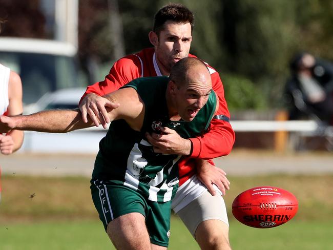 Adam Winter of Glenroy tackles Clayton Rogers of Airport West during the EDFL footy: Airport West v Glenroy played at Airport West on Saturday 4th May, 2019.