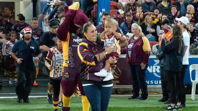 Quaden leads the Broncos out onto Suncorp Stadium during the NRL indigenous round.