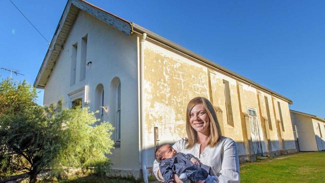 TWO CHANGES: Bree Dahl with her new baby Ivy in front of the historic Oddfellows Hall she purchased at auction and will renovate into a house. Picture: Adam Hourigan