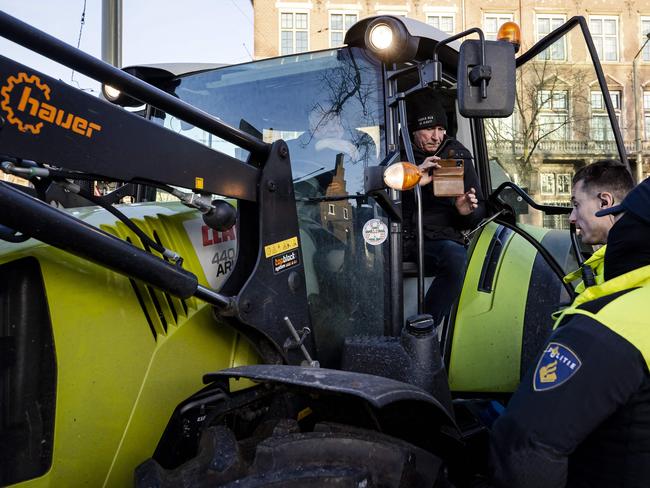 Police officers stop a tractor from entering the Binnenhof during a protest against coronavirus measures. Picture: AFP / Netherlands OUT