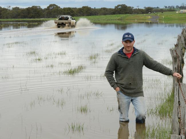 Wal Dyer checks out the flood damage to a friends Canola crop in Sandford. Picture: Karla Northcott