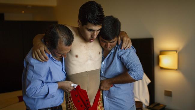 Spanish bullfighter Alvaro Lorenzo is dressed by his assistants. Picture: Daniel Ochoa de Olza