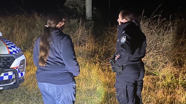 A resident speaks with a police officer near the scene of a fatal plane crash in bushland beside Commissioners Flat Road at Peachester. Picture: Natalie Wynne