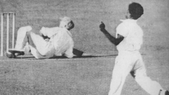 Eddie Gilbert puts Donald Bradman on the ground as he gets him out for a duck at the Gabba in Brisbane in 1931.