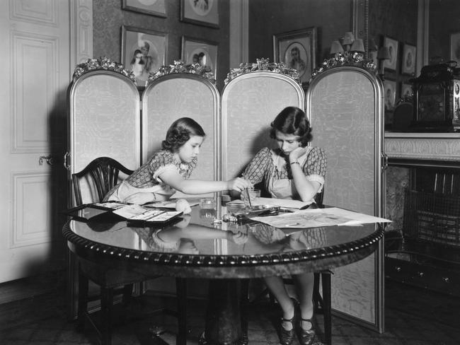 The sisters working on paintings in the school room of Buckingham Palace. Picture: Getty