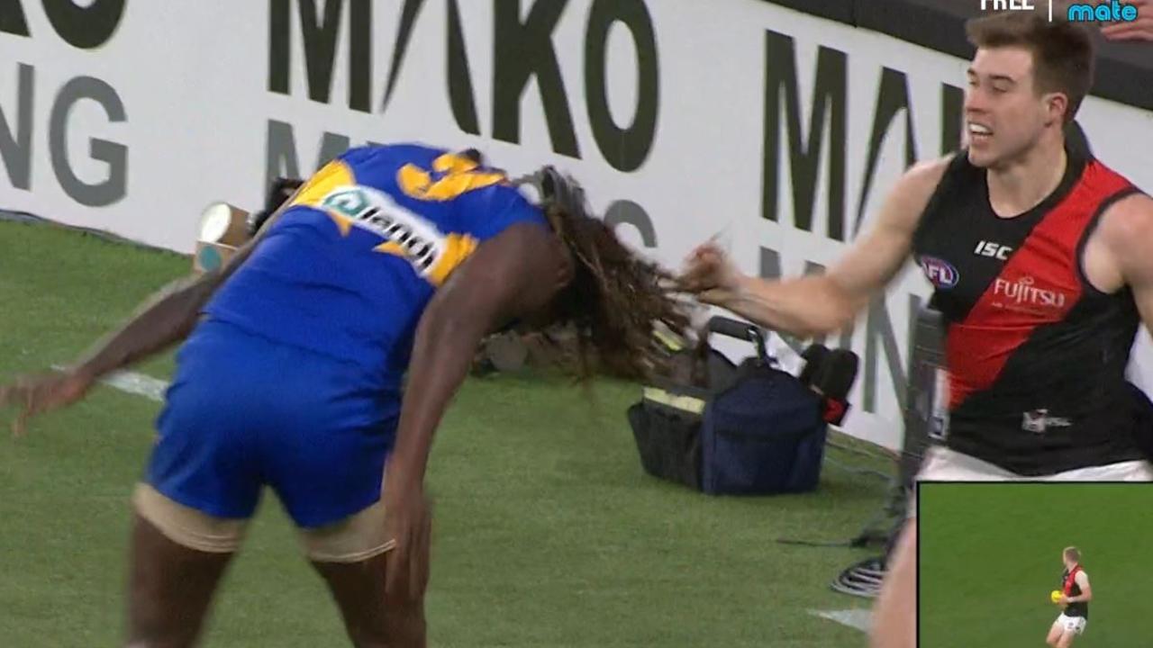 Essendon's Zach Merrett pulls on West Coast's Nic Naitanui's hair.