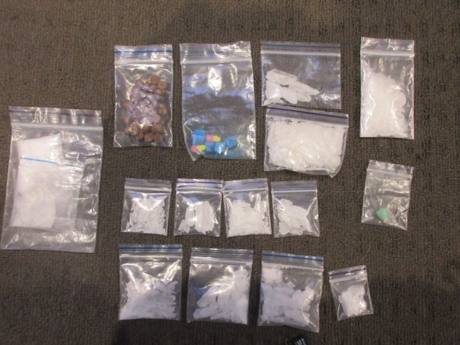 Police have seized cash, drugs, a stolen car and precious gems after executing a search warrant.