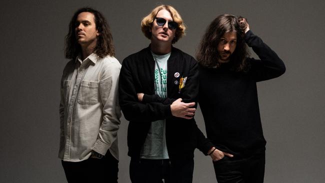 Brisbane rock band DZ Deathrays, whose fifth album 'Positive Rising Part 2' was released in 2021. L-R: Shane Parsons (vocals/guitar), Simon Ridley (drums) and Lachlan Ewbank (lead guitar/vocals). Picture: Marcus Coblyn