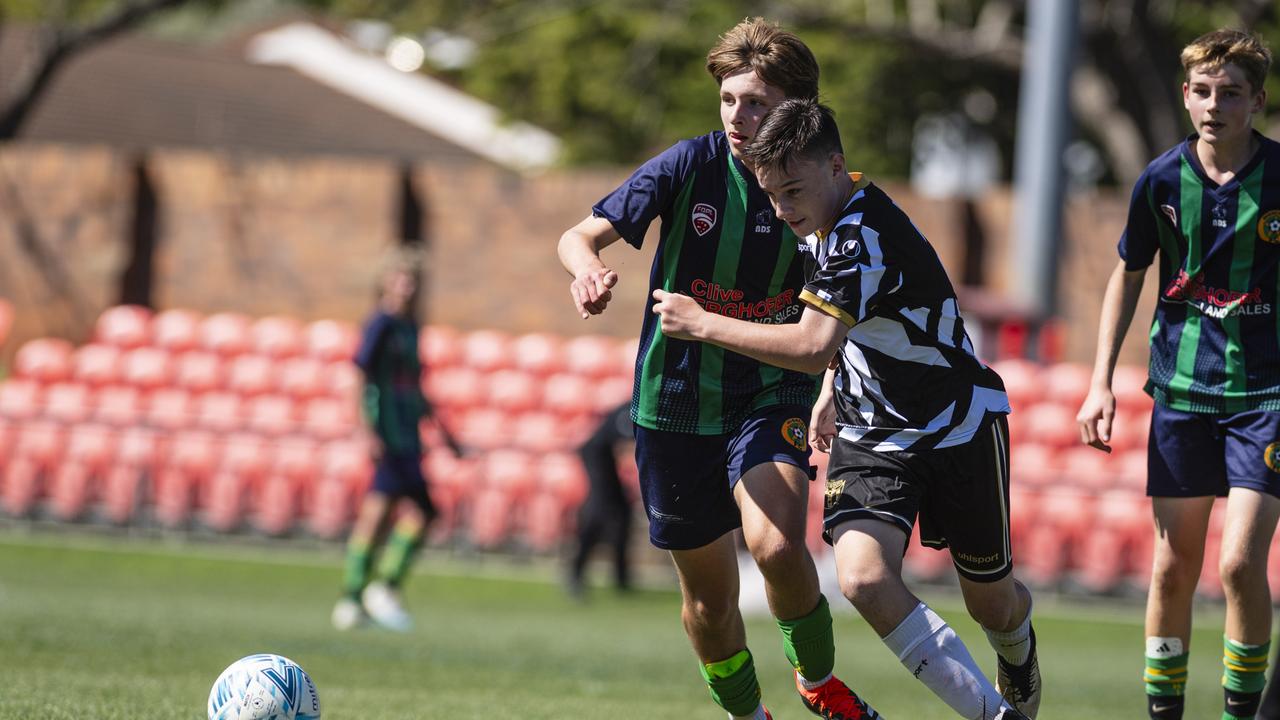 Wil Ehrlich (left) of Highfields and Liam Burges of Willowburn White in Football Queensland Darling Downs Community Juniors U14/15 Junior League grand final at Clive Berghofer Stadium, Saturday, August 31, 2024. Picture: Kevin Farmer