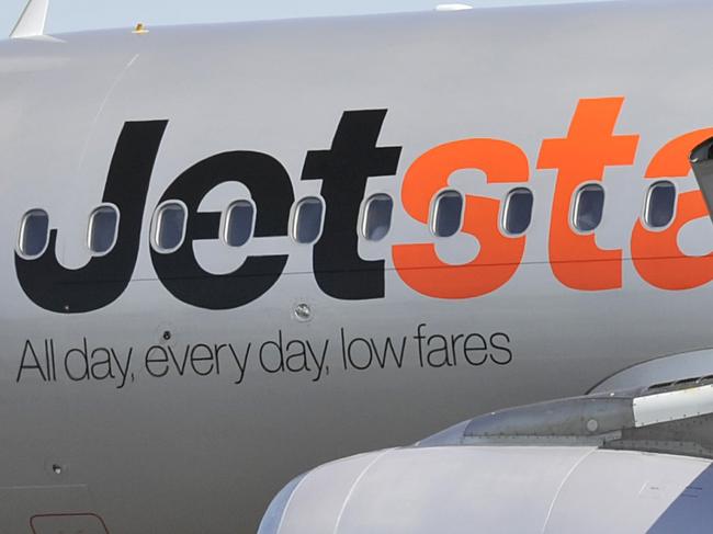 Jetstar aircraft seen at Sydney International Airport, Sydney, Friday, Aug. 12, 2016. International air passengers are being warned of potential disruption and delays when union members in the Department of Immigration and Border Protection strike for 24 hours. (AAP Image/Joel Carrett) NO ARCHIVING