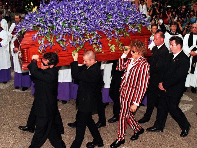 INXS band members Andrew Farriss and Garry Beers, and Hutchence’s brother Rhett, carry Michael Hutchence’s coffin out of St Andrew's Cathedral in Sydney. Picture: Jeff Darmanin