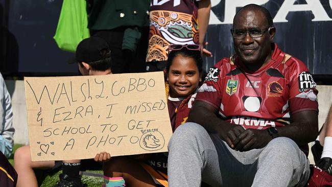 Ivy Marika, 9, with her grandad Luke Kuiha, watching the Broncos train. Picture: Lyndon Mechielsen