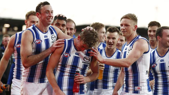 Todd Goldstein, Trent Dumont and Jack Ziebell of the Kangaroos celebrate.