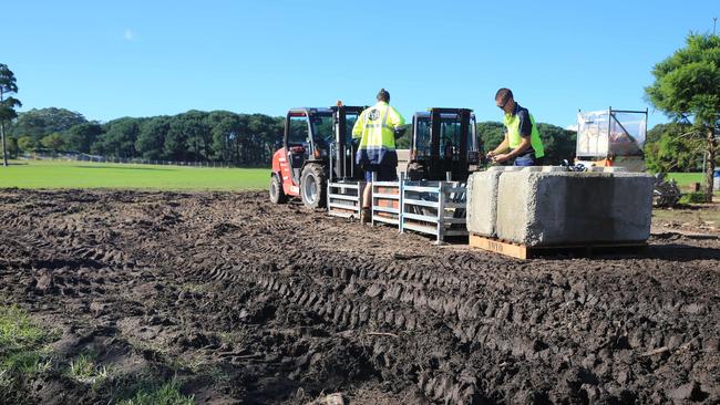 Workers remove equipment from Centennial Park, which was affected when storms hit Sydney.