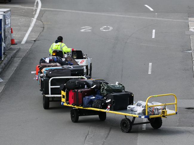 SYDNEY, AUSTRALIA - September 04, 2022: A general view of a QF baggage carrier transporting luggage to the terminal   at the International Airport as Qantas ground workers prepare to strike again with Qantas passengers facing major disruptions after ground handlers vote to strike over the airline's âdistressingâ wages crisis in Sydney. Picture Newscorp - Daily Telegraph/ Gaye Gerard.