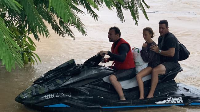 Surfing legends Joel Parkinson and Mick Fanning have been spotted rescuing flood victims in northern NSW.