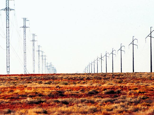Lines of electricity and telephone poles cross the desert towards Woomera in Australia's Outback pictured Jan 28 2002.  (AP PicRob/Griffith) travel SA arid power supply pole harsh landscape
