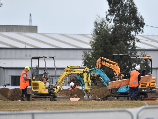 Workmen are seen digging a series of graves at the Memorial Park Cemetery in Christchurch. Picture: AP