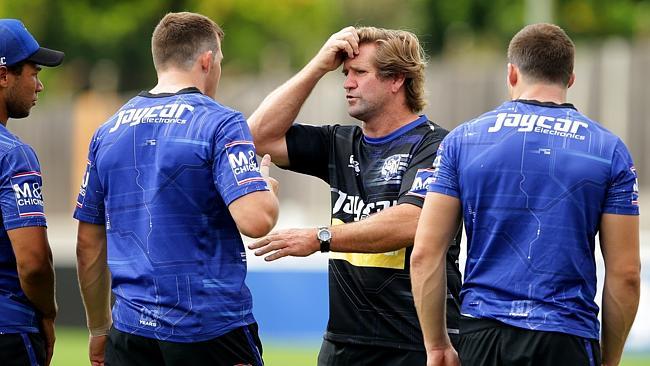 Coach Des Hasler talks to his players.