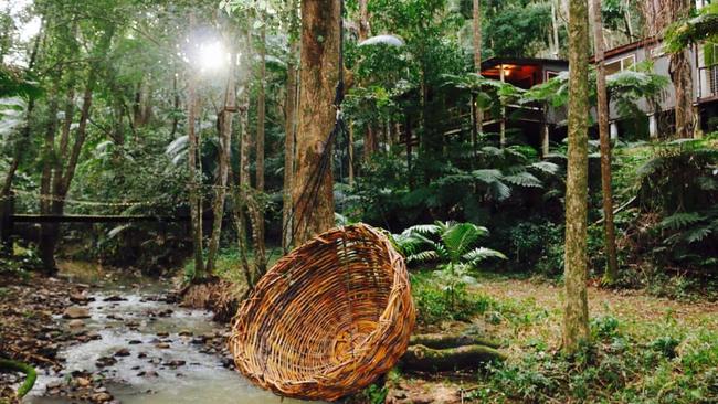 Cuddle above the creek in this swinging love nest at a Main Arm rainforest retreat listed on Airbnb