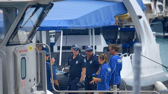 Paramedics treat two men after they were bitten by a shark in the Whitsundays.