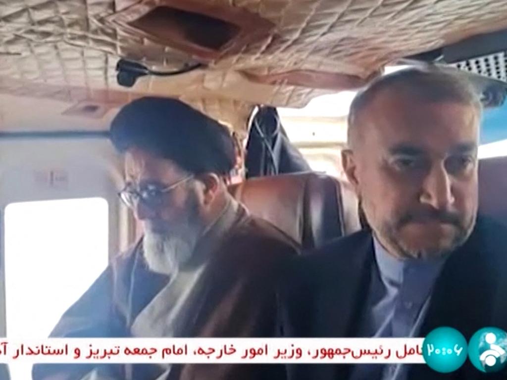 This grab taken from video footage released by the IRINN Iranian state television network on May 19, 2024 shows the Islamic republic's Foreign Minister Hossein Amir-Abdollahian (R) on board a helicopter in the Jofa region of Iran's western province. Picture: AFP