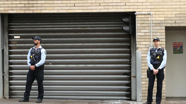 AFP officers guarding the rear doors of the CFMEU offices during the raid. Picture: John Grainger