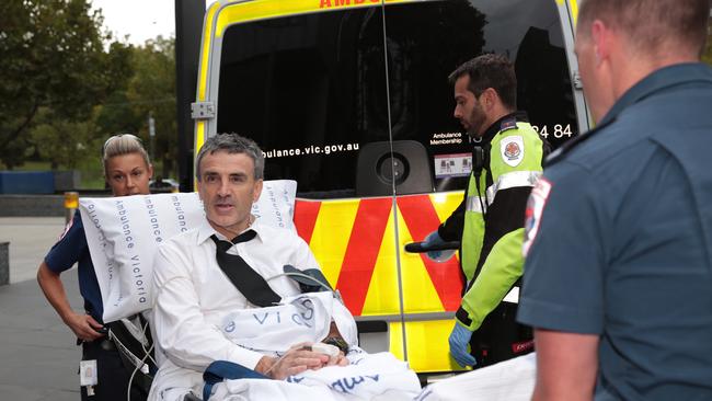 Terry McMaster leaves the royal commission in an ambulance after collapsing while being questioned in April. Picture: AAP