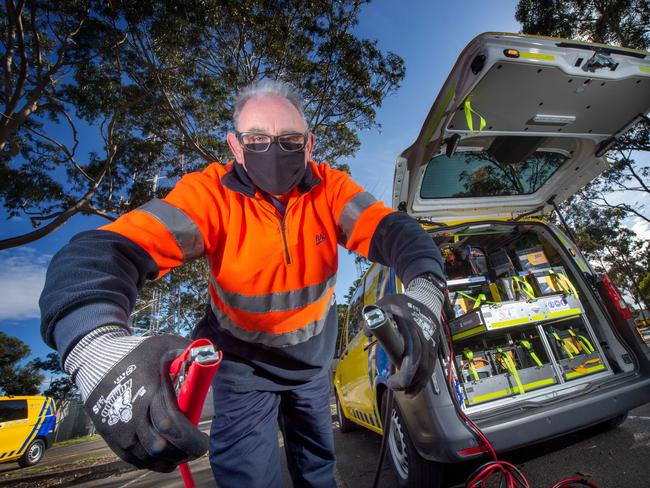 RACV are seeing a 9 per cent increase in callouts as car batteries go flat due to people staying at home during covid restrictions. RACV's roadside assistant Patrick Griffin checks out a battery. Picture: Tony Gough