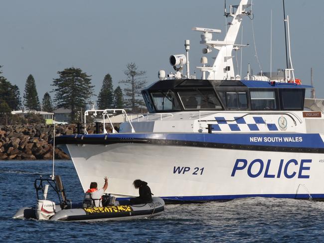 NEWCASTLE. AUSTRALIA. NewsWire Photos.23 November 2024. Photograph shows climate activists out this morning off Horseshoe Beach Newcastle as NSW Police Maritime Area Command vessels keep them at bay as bulk carries exit the port. Picture : Newswire/Dean Sewell.