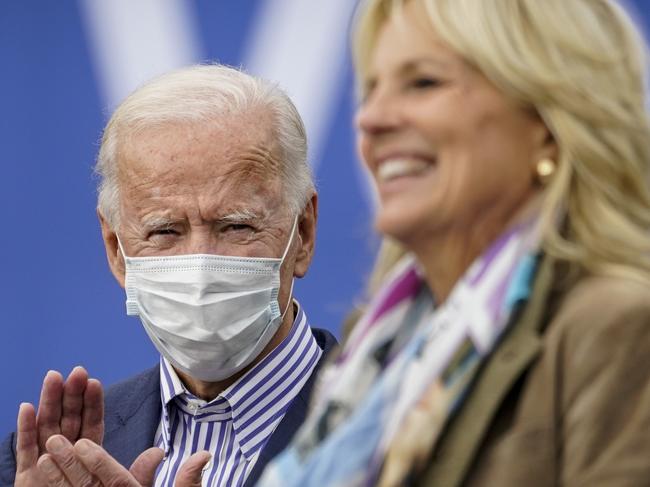 Democratic presidential nominee Joe Biden listens as his wife Dr Jill Biden speaks during a drive-in campaign rally in Pennsylvania. Picture: AFP