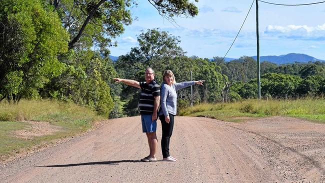 SPLIT: Lee and Colleen Wason on the road that cuts through their property, which was the central point on their recent appeal win against a Gympie Regional Council decision. Picture: Scott Kovacevic