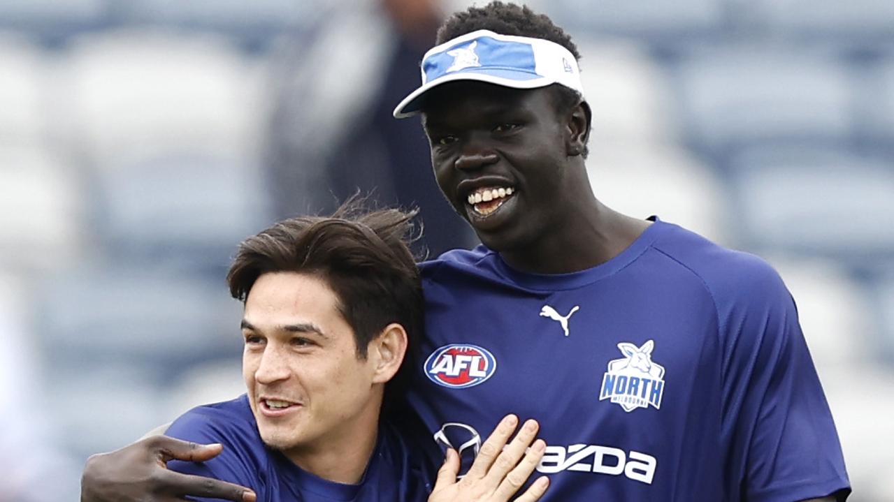 Bigoa Nyuon with Kangaroos teammate Zac Fisher. Picture: Darrian Traynor/Getty Images