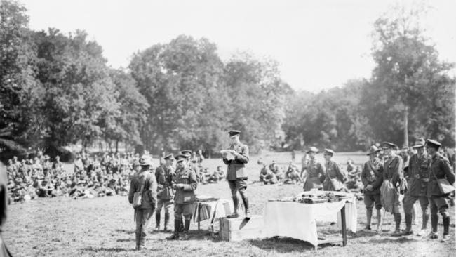 Lieutenant-General Sir John Monash presents decorations to members of the 4th Australian Infantry Brigade, after their success in the battle of Hamel at Somme, Querrieu in France during World War One (1918).