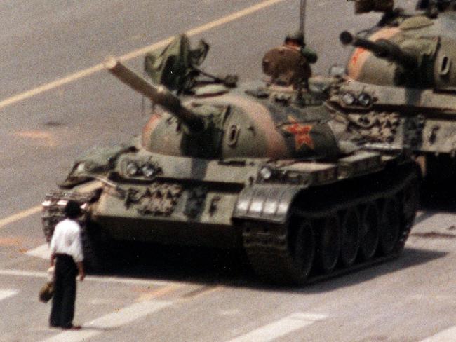 A Chinese protester blocks a line of tanks heading east onto Cangan Boulevard in front of the Beijing Hotel in China 05/06/1989. The man, calling for an end to the violence and bloodshed against pro-democracy demonstrators, was pulled away by bystanders, and the tanks continued on their way, the days after the Chinese military assault on demonstrators on the night of 03/06/1989 - 04/06/1989 in Tiananmen Square.