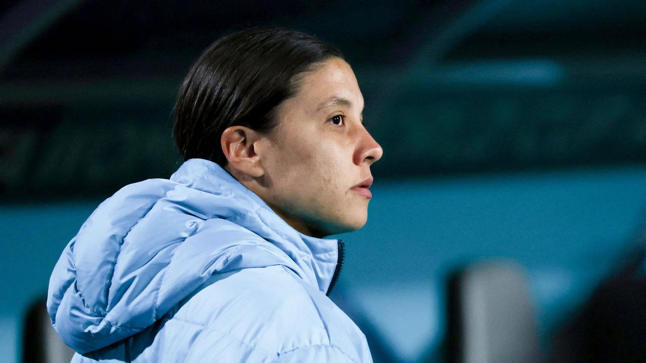 A devastated Sam Kerr looks on after being ruled out of Australia’s opener with a calf injury. Picture: AFP