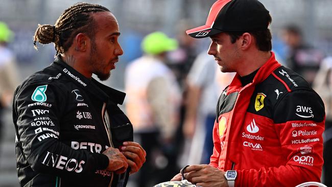 Mercedes' British driver Lewis Hamilton (L) speaks with Ferrari's Monegasque driver Charles Leclerc after the Sprint race at the Circuit of the Americas in Austin, Texas, on October 21, 2023 ahead of the United States Formula One Grand Prix. Hamilton placed second with Leclerc finishing third. (Photo by Chandan Khanna / AFP)