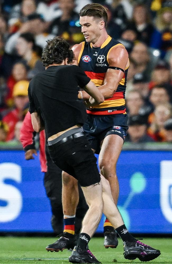 Ben Keays knocks the pitch invader to the ground. Picture: Mark Brake/Getty Images