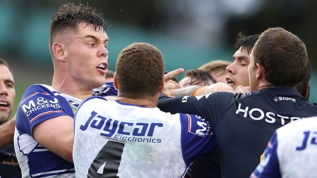 Bulldogs enforcer David Klemmer scuffles with Storm players.