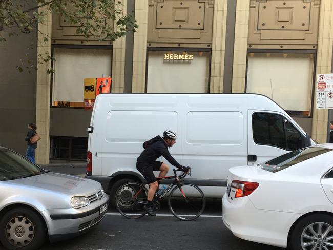 A van parked in a bike lane on Exhibition St.