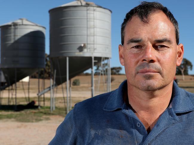 President of the Western Australian Farmers Federation and mixed grains farmer Rhys Turton poses for a photograph next to his barley seed silos near York in the Wheatbelt region, 100km east of Perth on Tuesday, May 19, 2020. China today imposed an 80% tariff on barley imports from Australia. Barley usually makes up about 30% of his total crop but he will now be substituting most of his barley for other grains. (AAP Image/Richard Wainwright) NO ARCHIVING