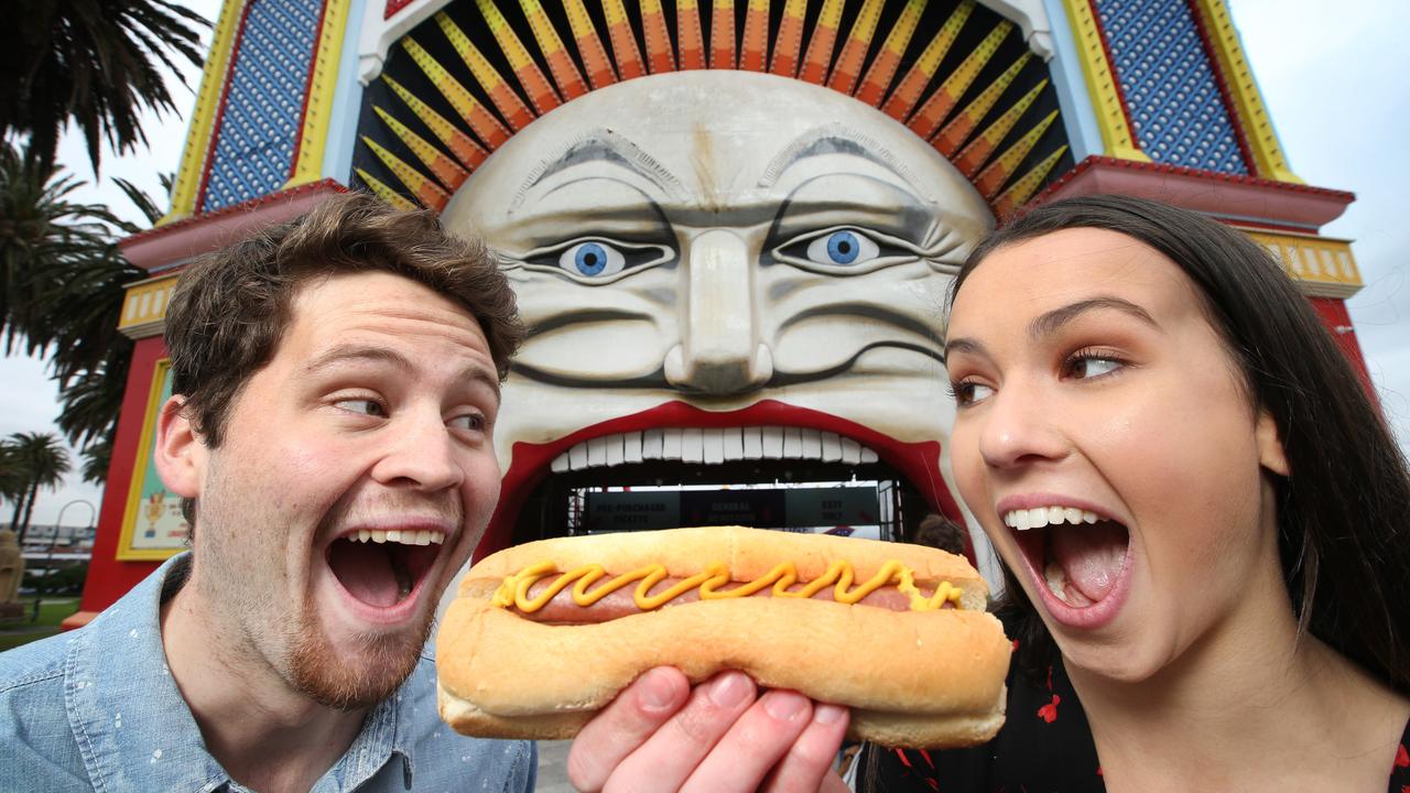 Hotdog lovers Patrick Brinkley and Bonnie Cottam enjoy a classic amusement park treat on a Luna Park outing. Picture: David Caird.