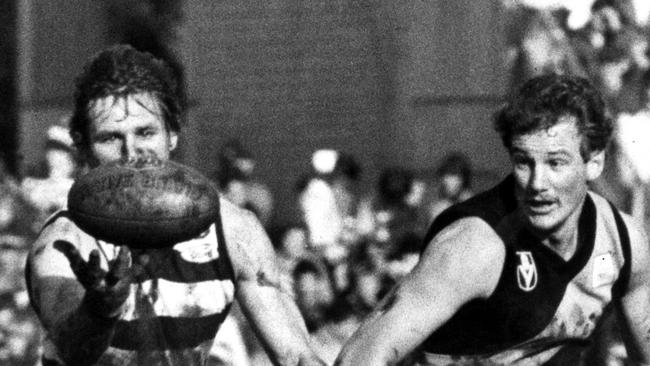 Jack Hawkins (left) vies with Michael Roach for possession during a VFL game in 1981. 